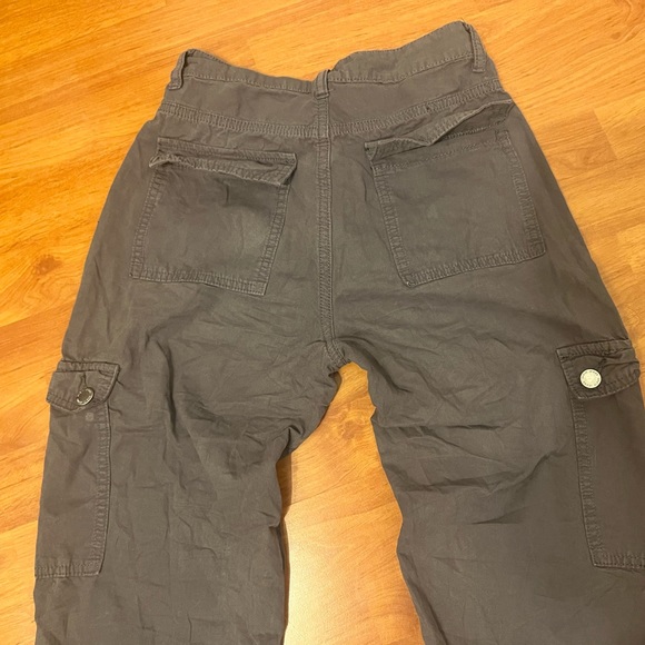 Grey cargos with pockets all over the front of it and visible grey seams. - Picture 5 of 5